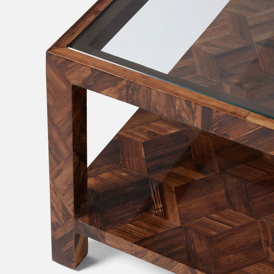 Modern wooden table with geometric pattern on glass top and metal frame.