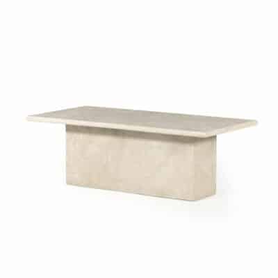 Cream marble coffee table with block plinth base, showcasing the natural coloration and veining patterns of the material in a close-up image.