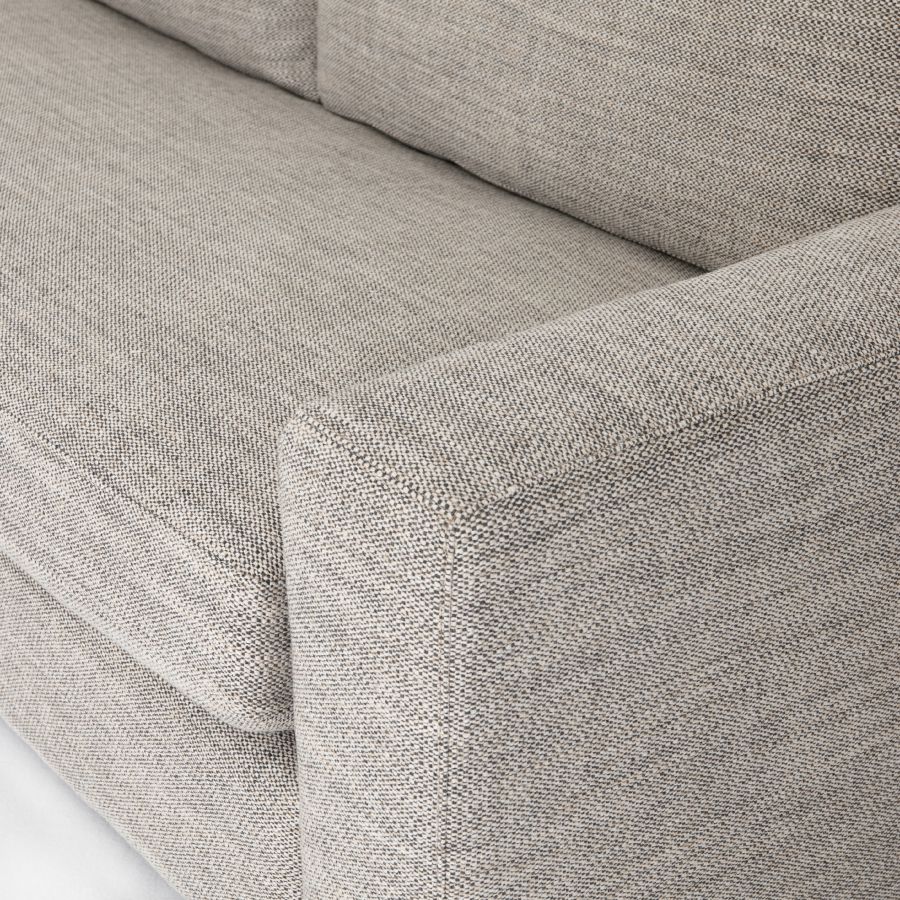 This is an image of a modern block sofa showcasing its design and texture in both performance grade cream and coal upholstery