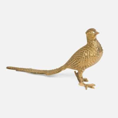 Golden brass bird statue with intricate details.