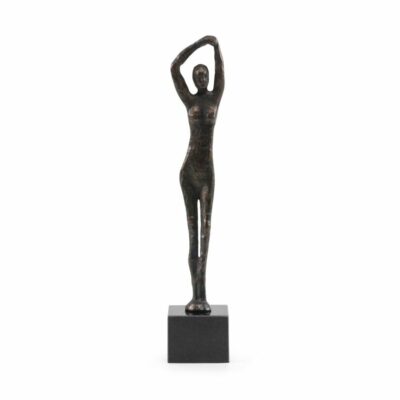 Bronzed statue of a woman standing on a pedestal, elegant side profile view.