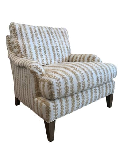Close-up of an Amherst chair in natural leaf print upholstery, showcasing its intricate design and craftsmanship.
