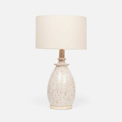 A decorative white and brown spotted table lamp with a matching shade.