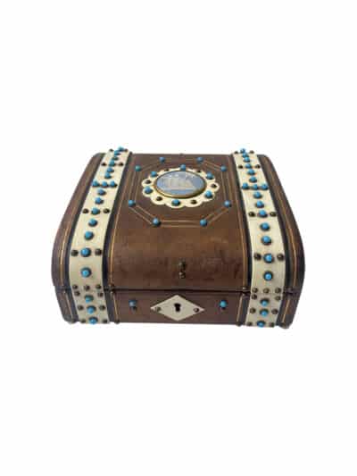 Vintage leather box with cameo inset and turquoise stone details, showcasing its antique charm.