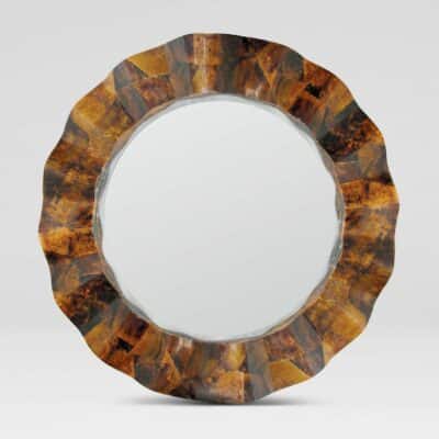 Large round mirror with scalloped edge, featuring a unique brown shell design on its frame.