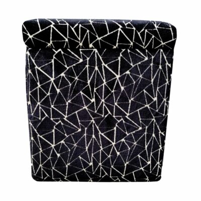 Close-up of black upholstered ottoman in triangle pattern.