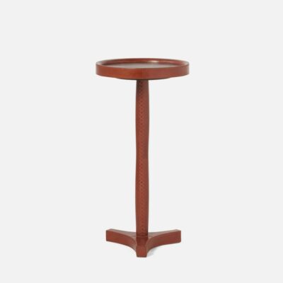Round pedestal side table in tobacco leather finish.