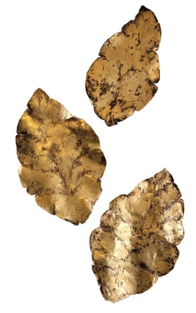 Handcrafted metal leaf sculptures in gold finish.