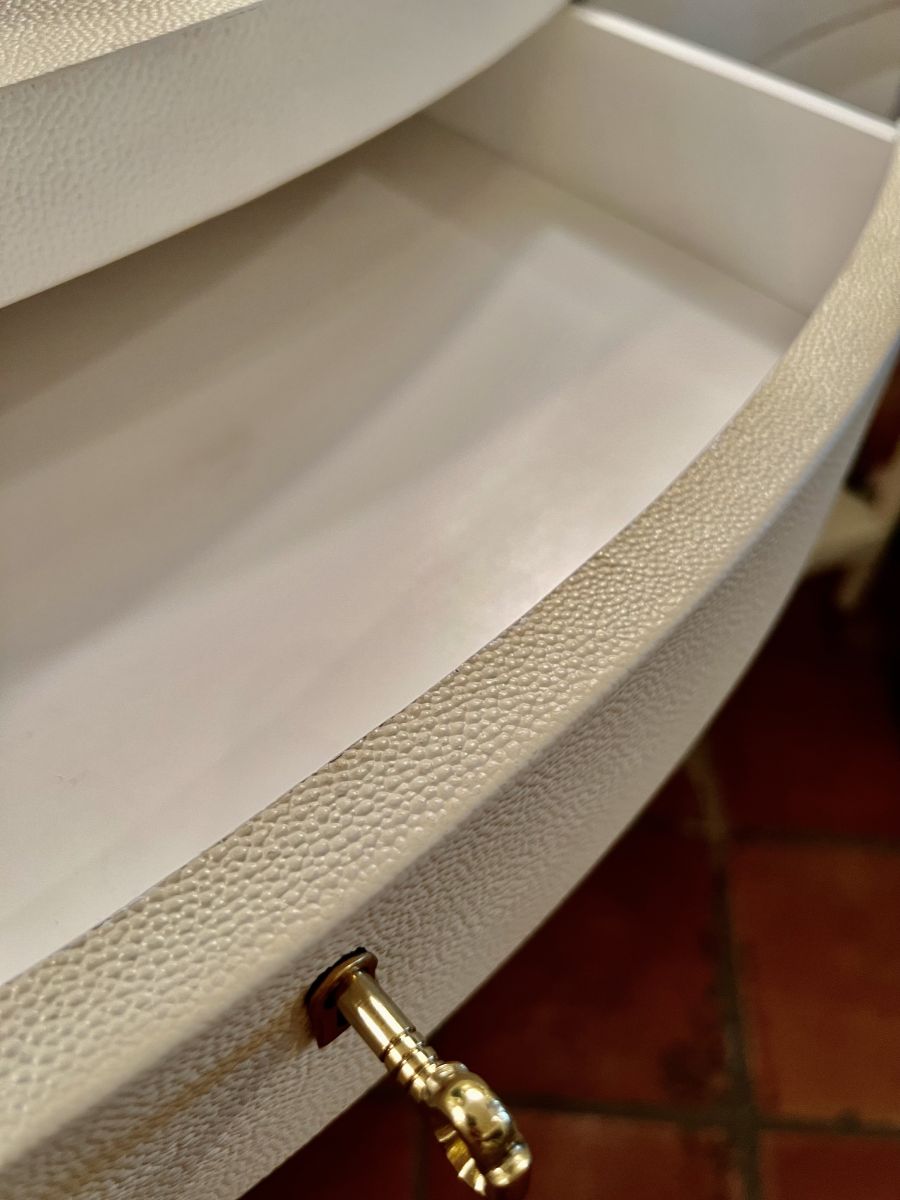 Close-up of Ivory Faux Shagreen Serpentine Front Console with Brass Keyhole Hardware, Satin Brass Ferrules on Tapered Legs.