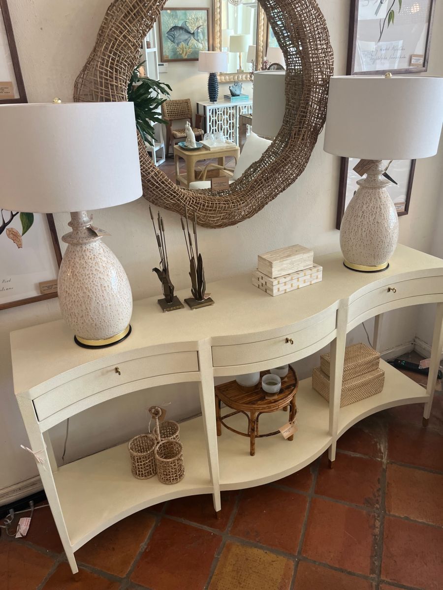Close-up of Ivory Faux Shagreen Serpentine Front Console, featuring Brass Finished Key with Keyhole Hardware Tapered Legs with Satin Brass Ferrules.
