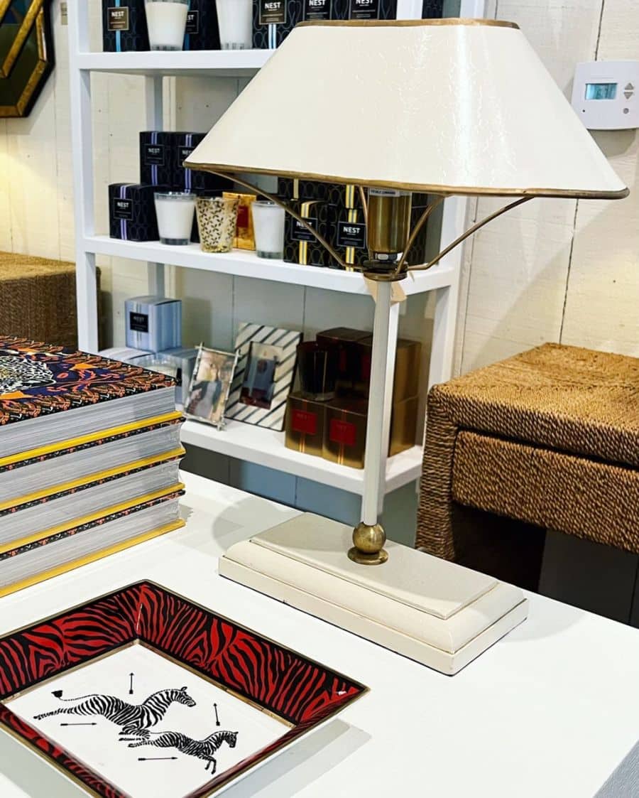 Elegant oval table lamp with brass base, gold painted trim, and textured white shade.