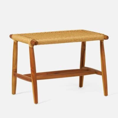 Small teak bench with woven seat in light stain, showcasing Scandinavian style design.