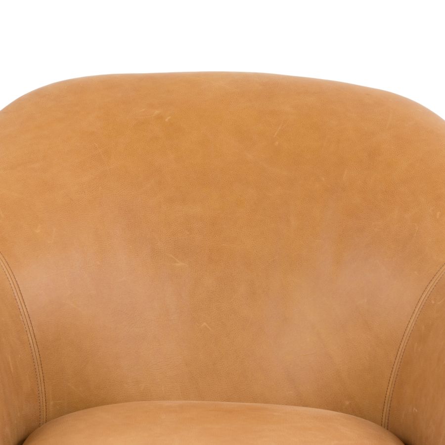 Close-up of butterscotch leather upholstery on mid-century style chair.
