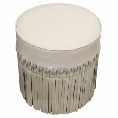 Round ottoman with ivory leather fringe, front view.