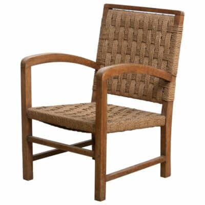 Vintage French arm chair with oak frame, curved wood arms, woven rope seat and back.
