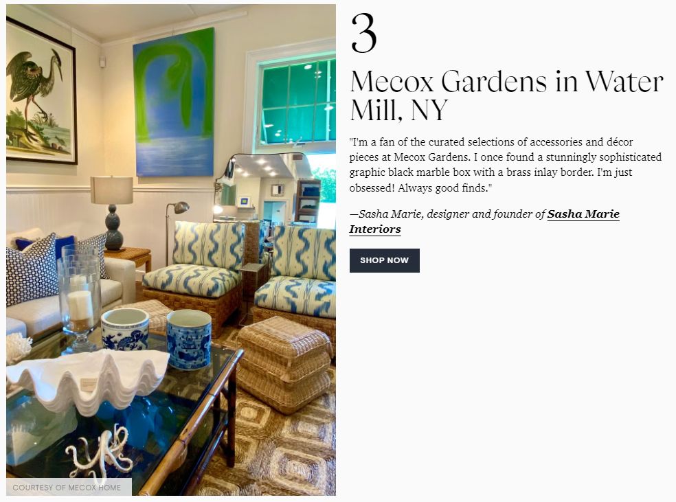 Brightly lit living room showcasing cozy blue patterned furniture and vibrant artwork.