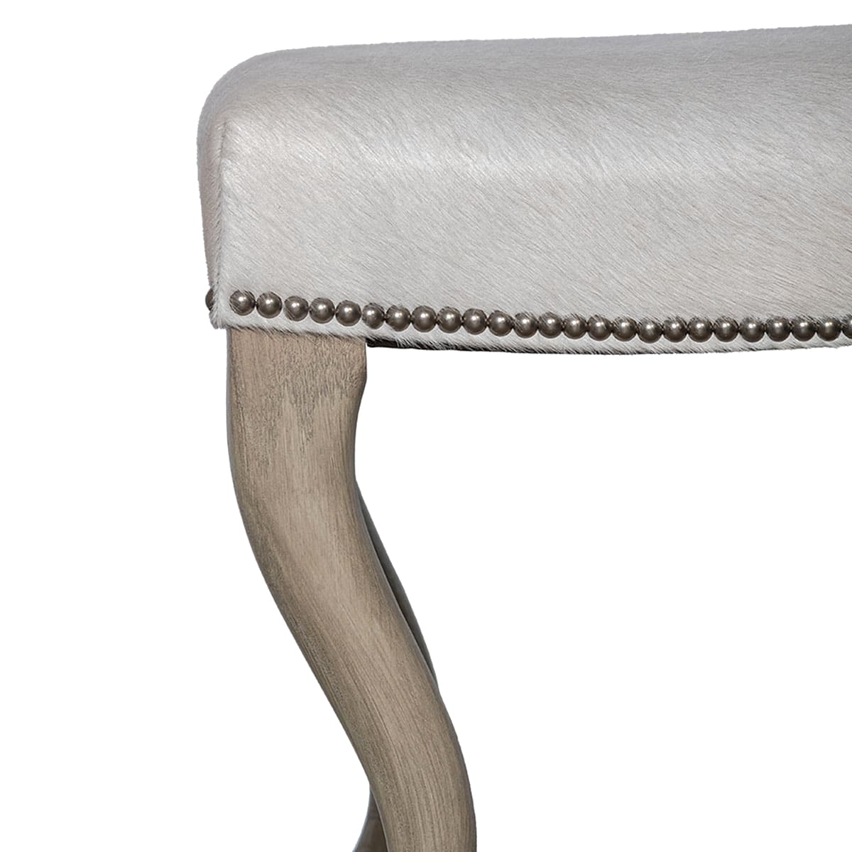 Close-up of Dune on Oak Finish Platinum Nailhead Trim Upholstered Hide Ottoman With Curved Wood Legs in Serengeti Natural Grade 7 Hide.