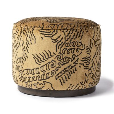 Close-up of round ochre ottoman with intricate design; also available in other fabrics and matching chair.
