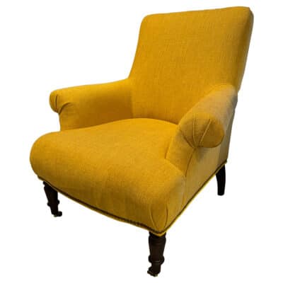 Yellow armchair with rolled arms, vintage chestnut finish, and turned legs.
