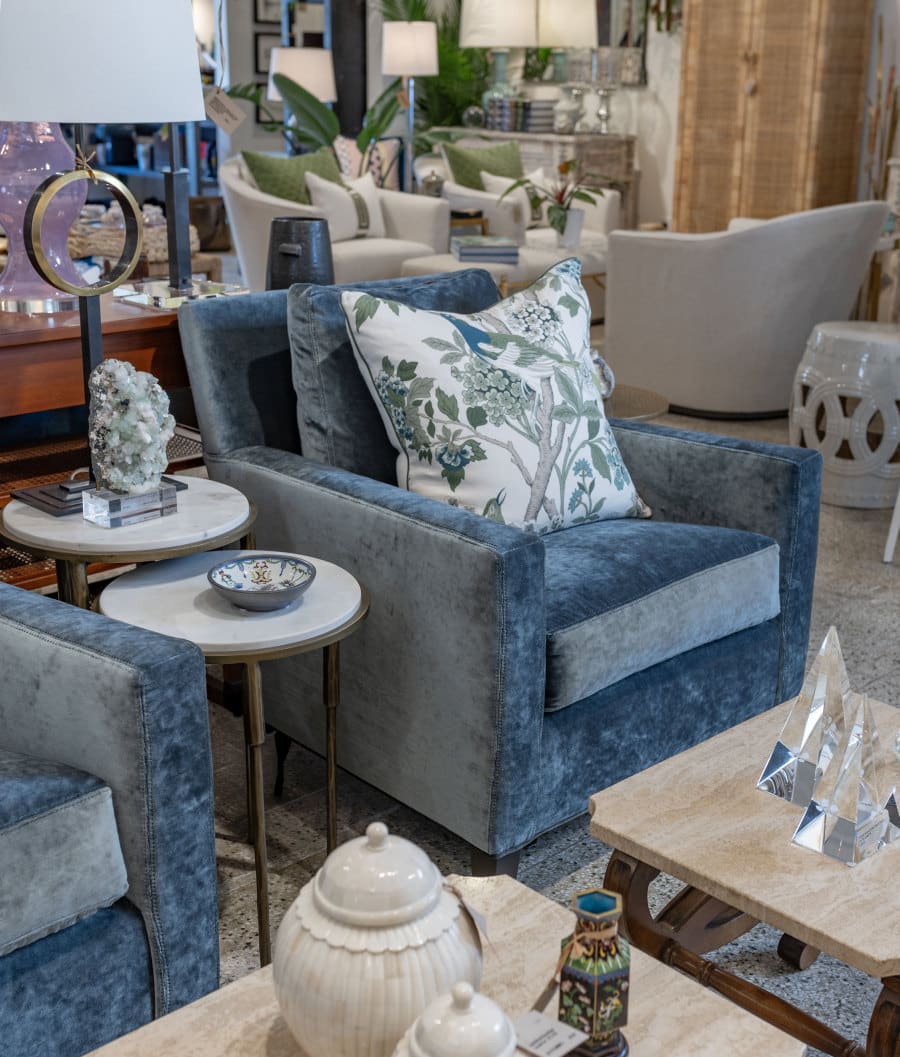 Close-up of Bellamy Upholstered Chair showcasing plush velvet upholstery in steel blue and brass capped feet.
