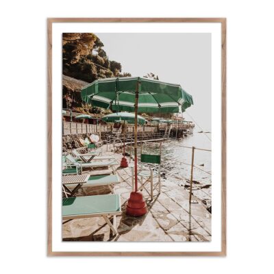 Brightly lit seaside cafe at dusk, framed in rustic walnut.