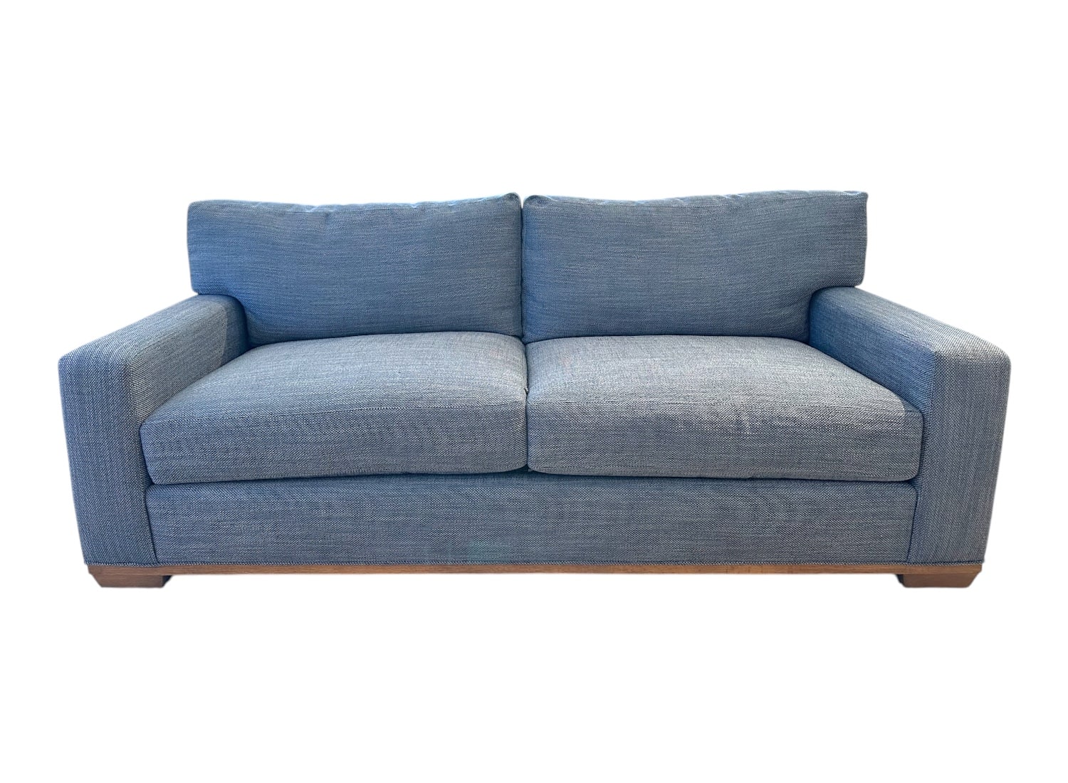 Blue upholstered apartment sofa with weathered grey legs, showcasing elegant design for comfortable living room seating.