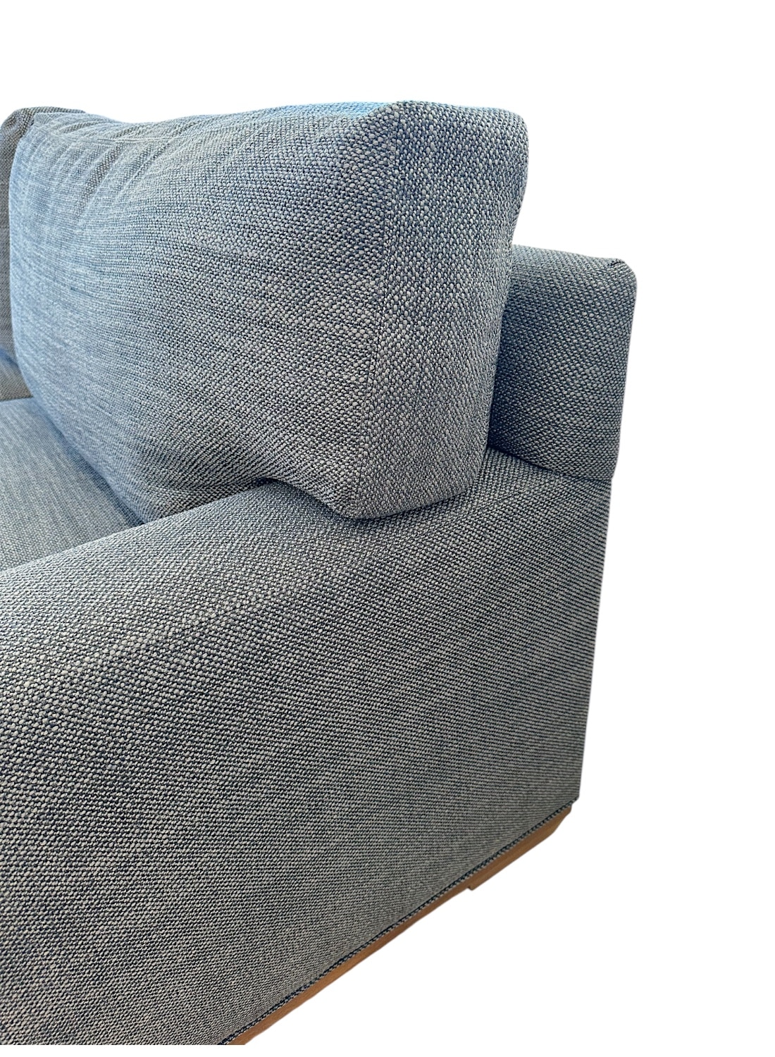 Blue upholstered apartment sofa, front view.