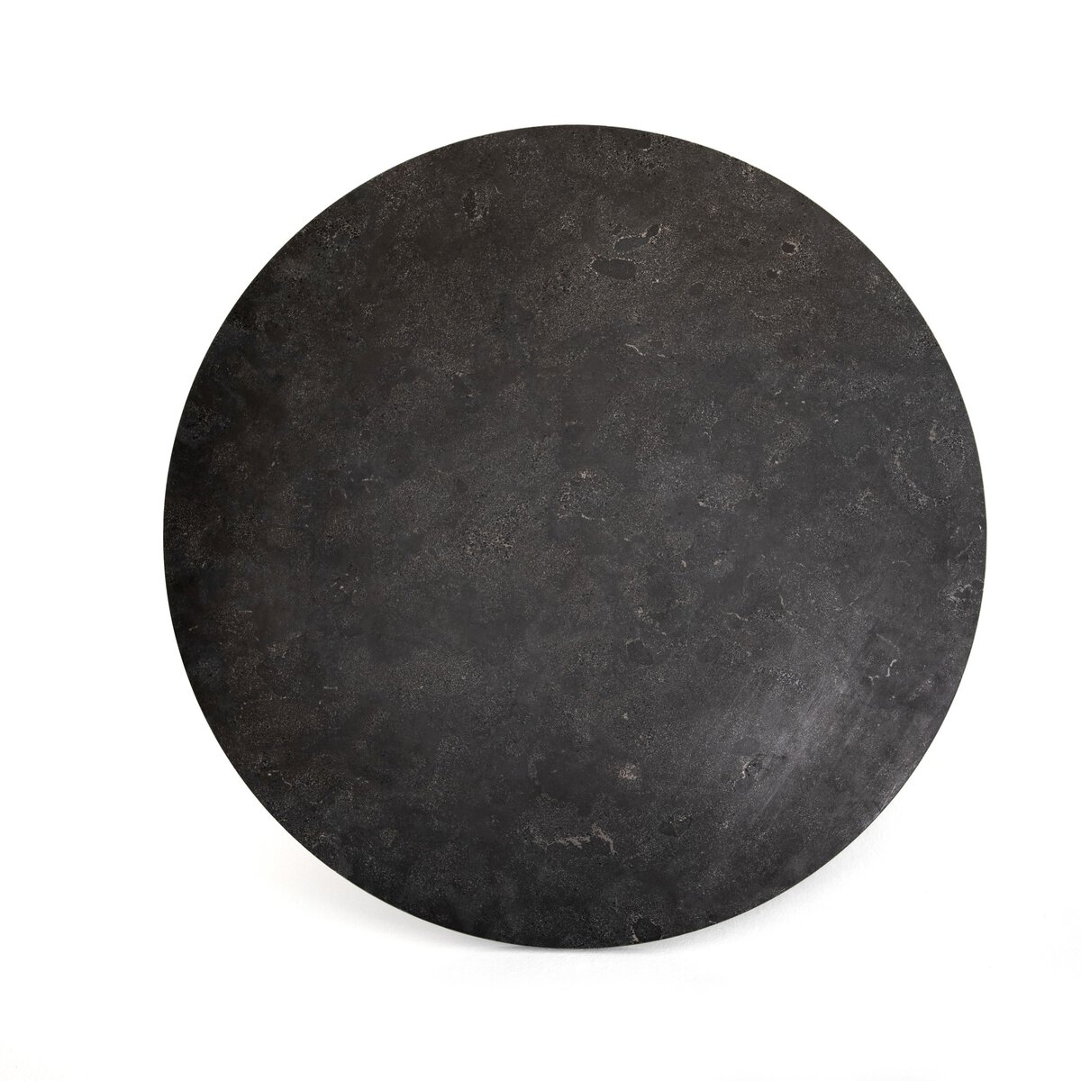 Close-up of round Powell dining table with black iron base and white marble top.
