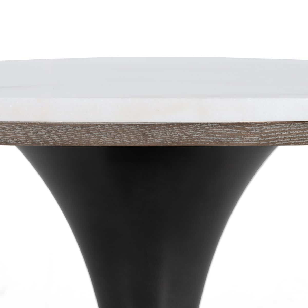 White marble top dining table with black iron base, elegant round shape.