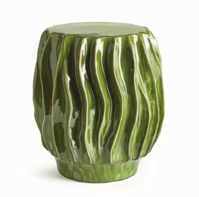 Close-up of wavy verdant green ceramic stool, handcrafted interior use only, each piece unique in size and color.