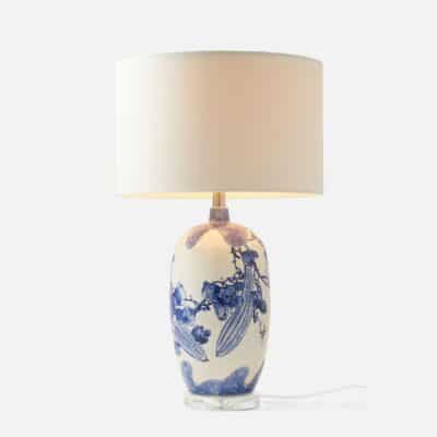 Close-up of Aziah Blue and White Ceramic Table Lamp featuring hand-painted floral design on white base.