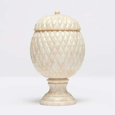 Top-down view of bone urn with intricate pineapple design.