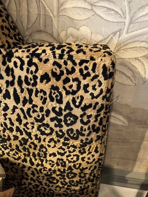 Close-up of Valerie King Bed in Jaguar Print, featuring luxurious upholstery and weathered gray finish.