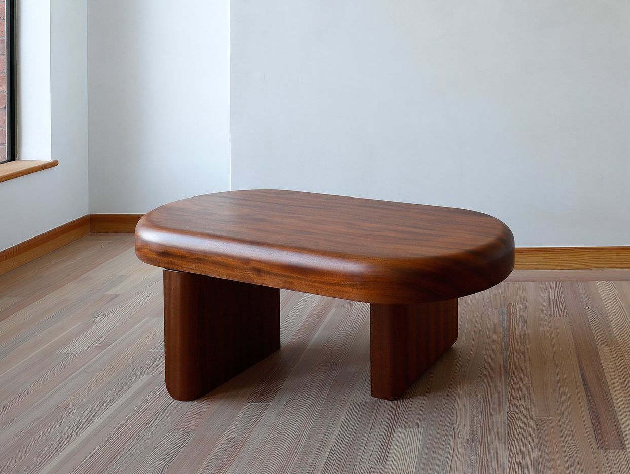 Handcrafted coffee table with solid sapele wood, featuring curved edges and a smooth finish.