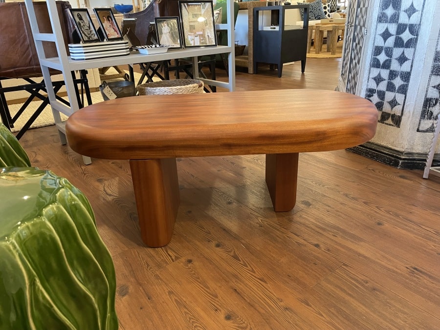 Handcrafted Sapele wood coffee table with chunky design and dull lacquer finish in a Hamptons setting.