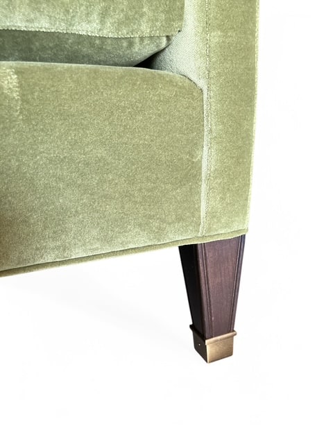 Close-up of Meadow Velvet Apartment Sofa with pecan finish on wood legs and brass ferrules, showcasing plush texture.