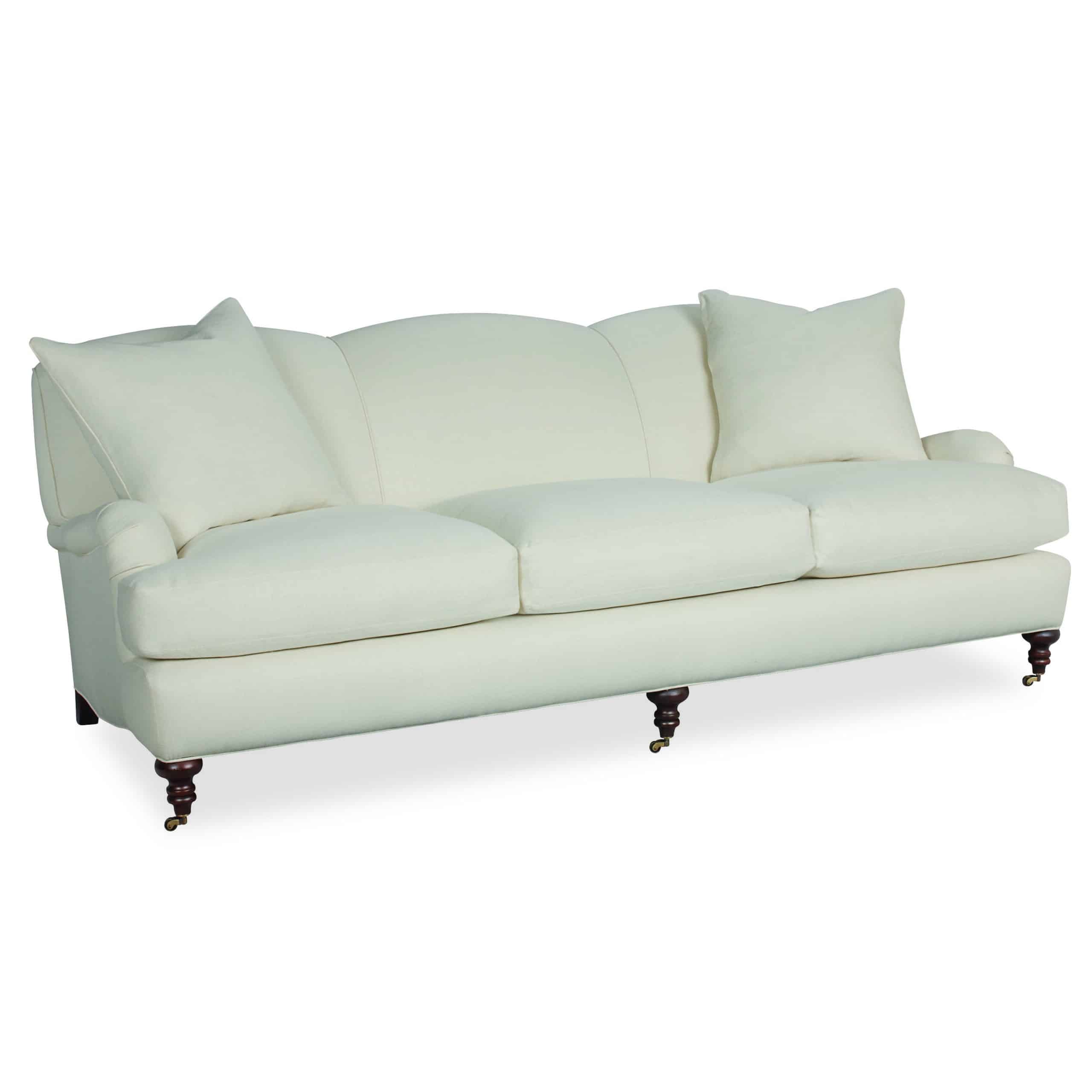 Classic sofa with English arm, brass casters, and rolled maple legs.