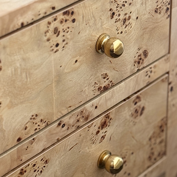 Close-up of Morton Night Stand in burl wood with polished brass hardware, showcasing its intricate details and rich grain pattern.