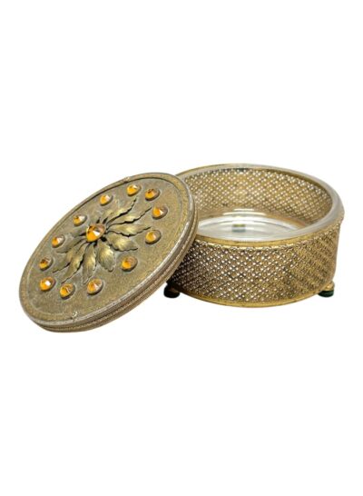 Antique brass box with ornate floral design on lid, glass interior, and intricate detailing.