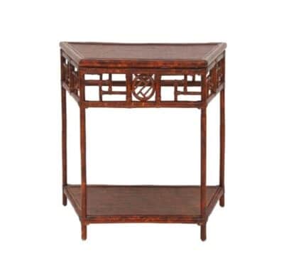 Side view of small Tortoise finish Demilune table with intricate carvings.