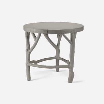 Alt Text: "Stone side table with branch legs in cloud gray, showcasing natural texture and design