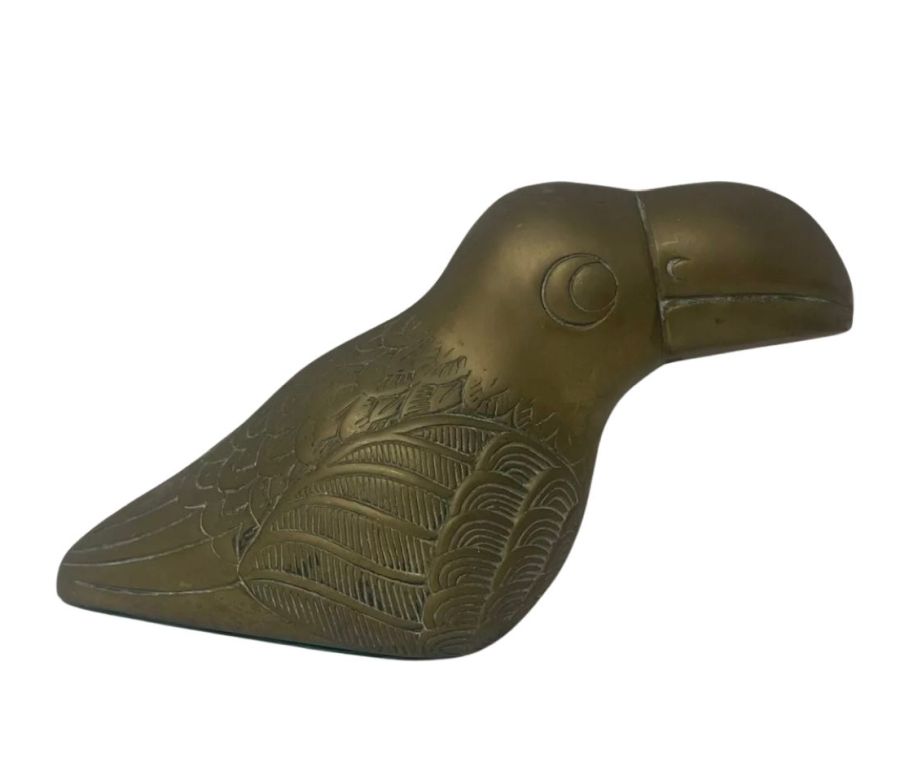 Vintage brass toucan figurine with intricate details and green felt base.