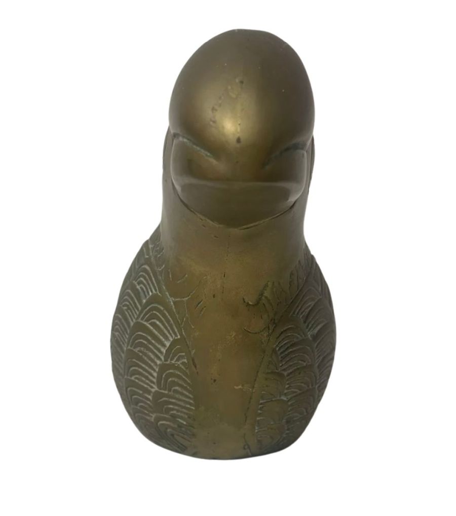 Front view of vintage brass toucan figurine with green felt base.