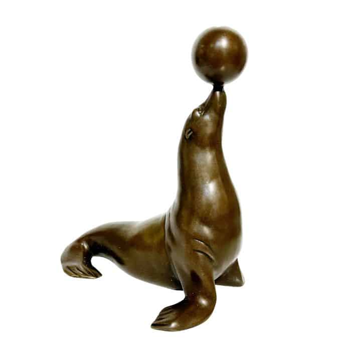 Bronze seal sculpture balancing ball on nose.