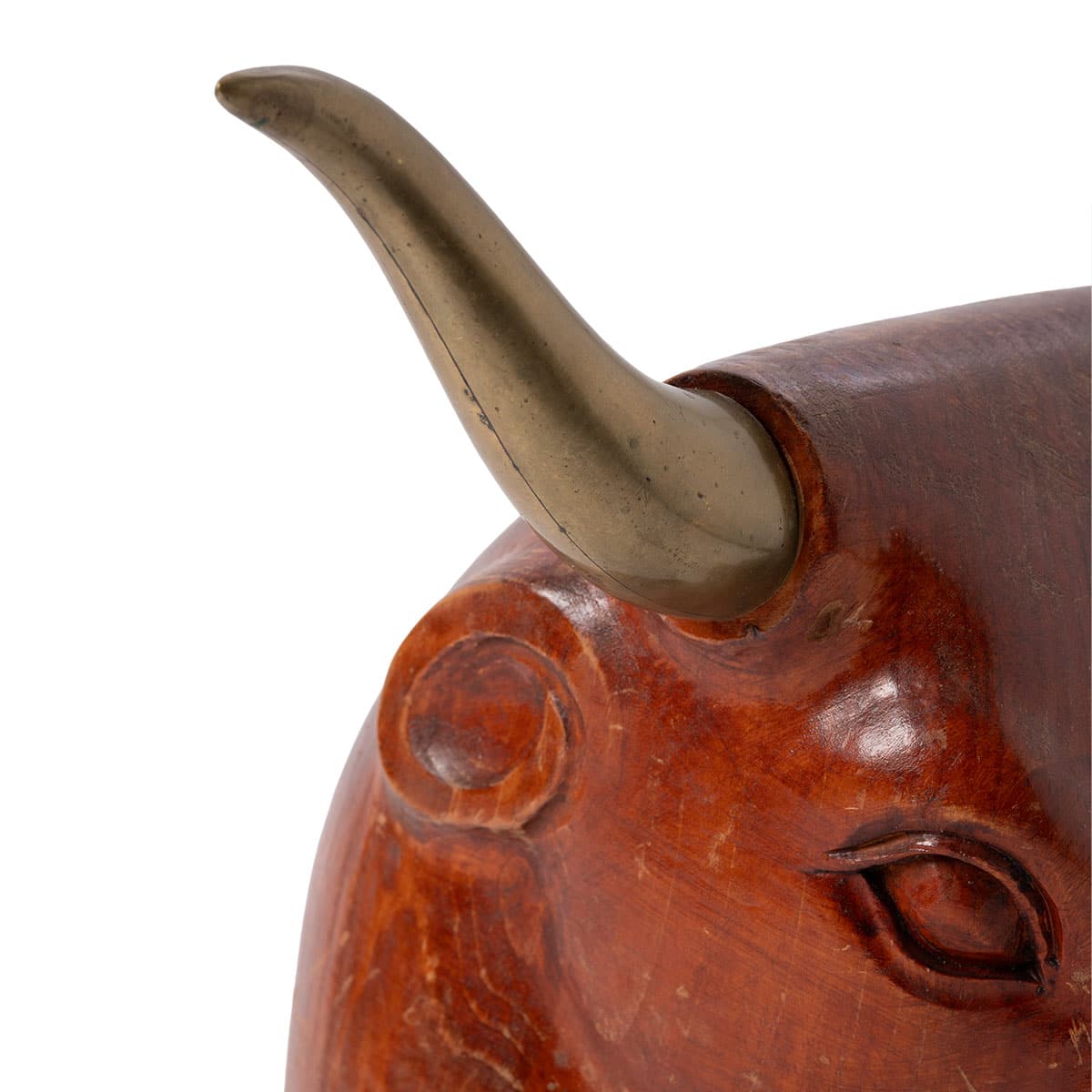 Close-up of vintage mid-century Spanish wooden bull head sculpture with brass horns.