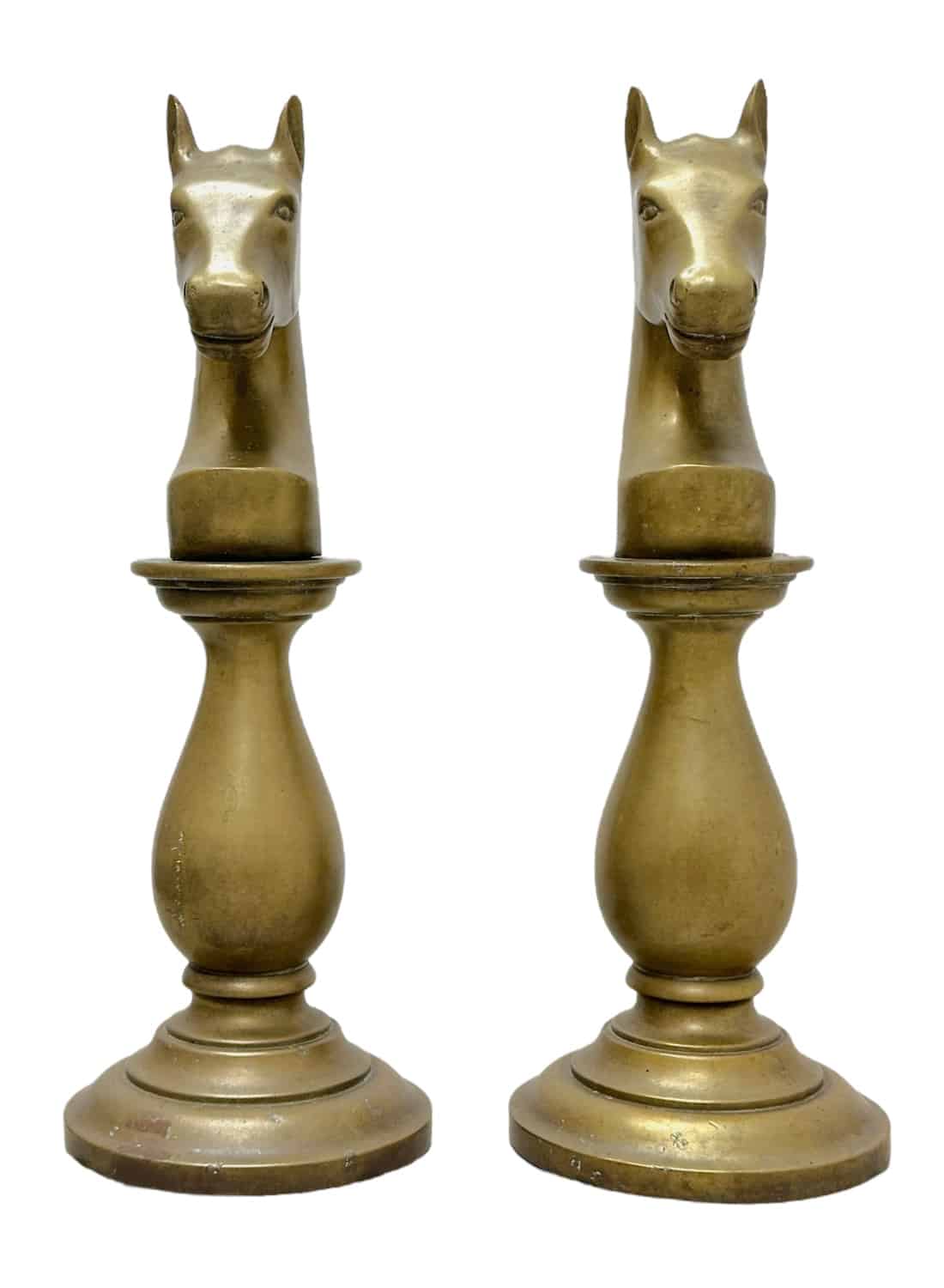 Pair of vintage brass horse chess pieces on round bases, front view.
