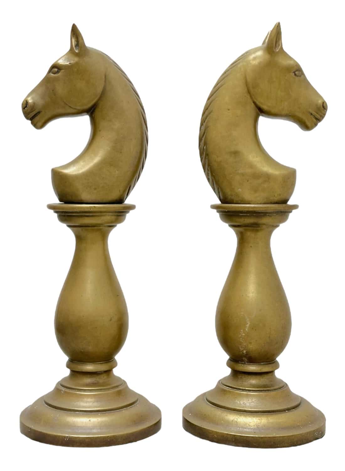 Heavy brass chess pieces in vintage style, featuring horse heads on round bases.