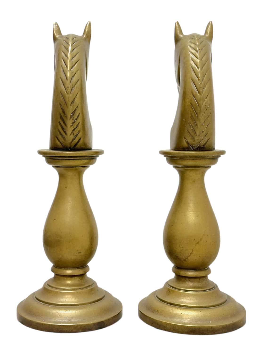 Beautiful brass chess pieces in horse shape, heavy and vintage, resting on round bases.