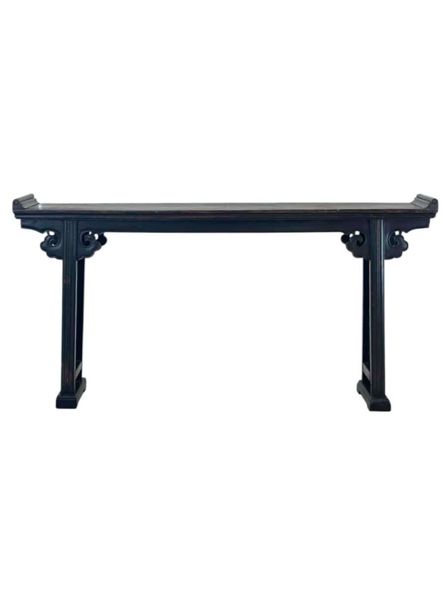 Close-up of antique Chinese double sided console featuring aged lacquered finish, traditional decorative fretwork on legs and apron.