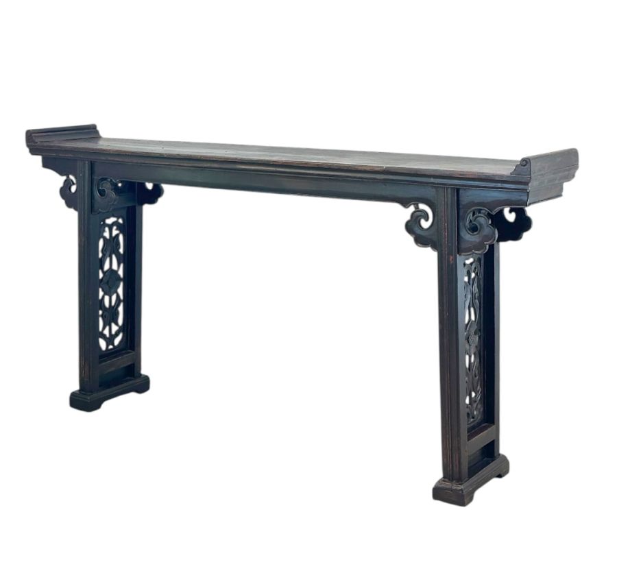 Antique Chinese double-sided console table with ornate carved fretwork on legs and apron, featuring an aged lacquered finish.